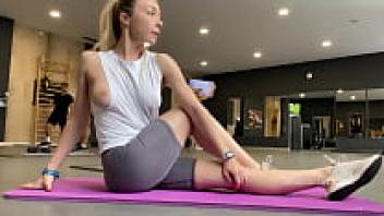exposing one's tits in public. A sporty girl displays her nipples in the gym.