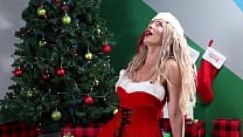 As she sings Christmas music, a gorgeous girl masturbates.