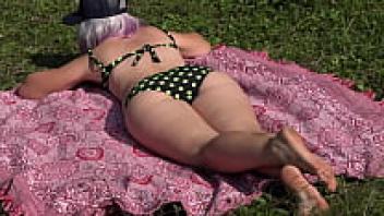 A voyeur in the woods observes a girl masturbating to climax with a squirt. Huge ass and hairy pussy.